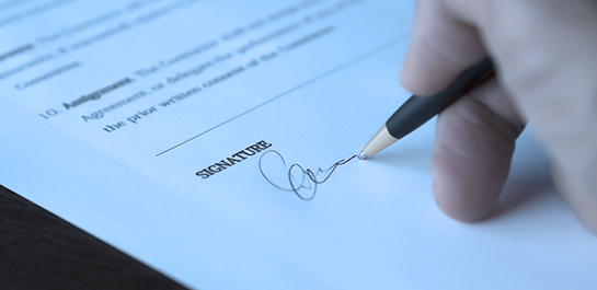 Hand signing document to commit business fraud